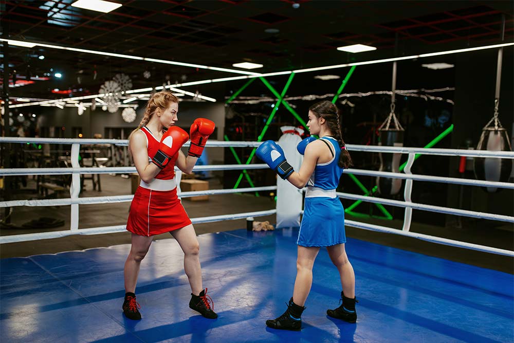 Two women boxing in the ring