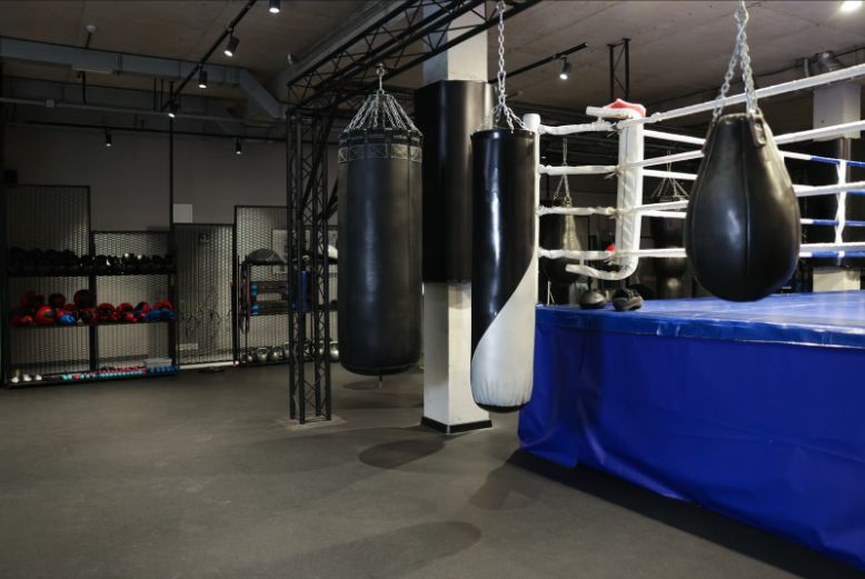 Punching bags beside a boxing ring